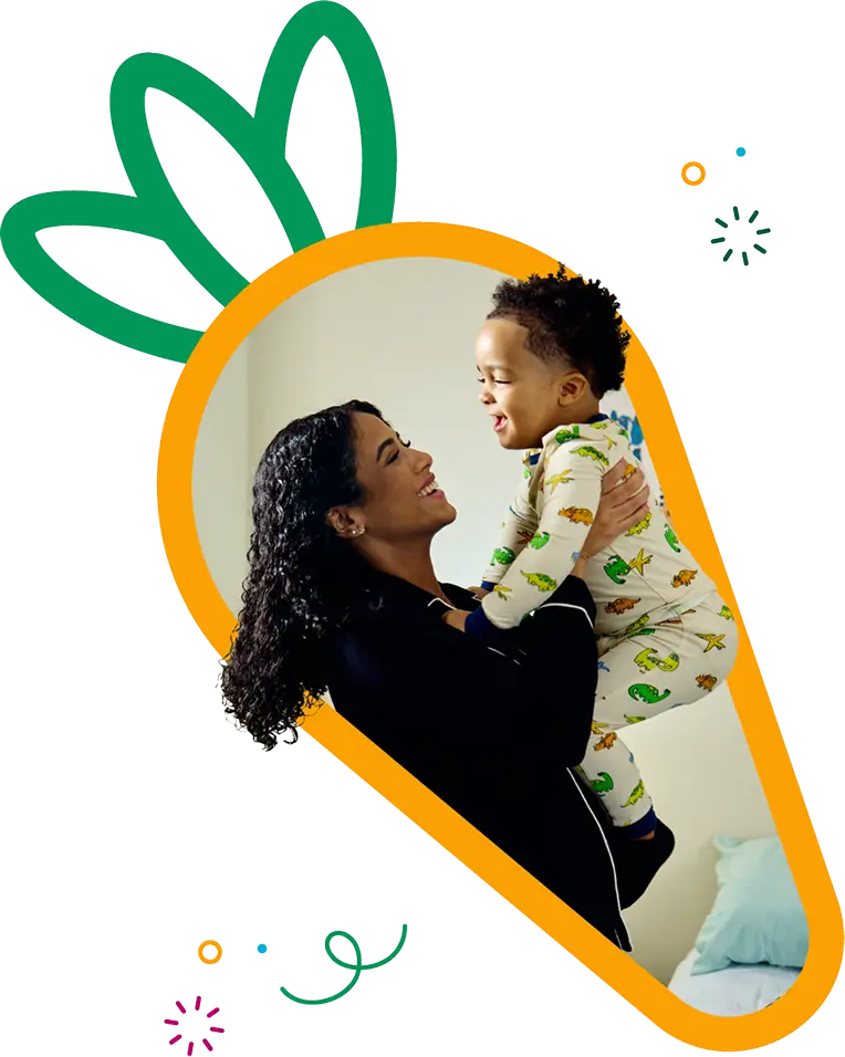 Mother holding baby in carrot frame