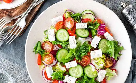 white bowl with greek salad