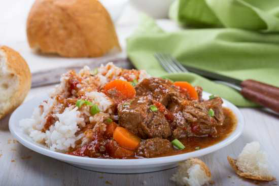 white bowl with beef and rice and vegetables