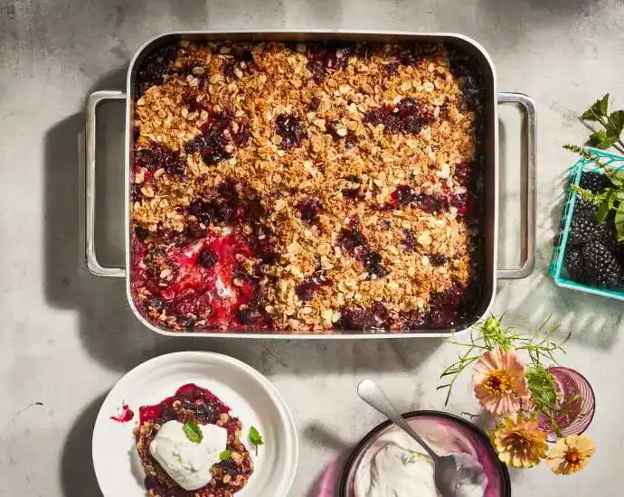 baking dish of berry breakfast bake with a portion on a plate to the side