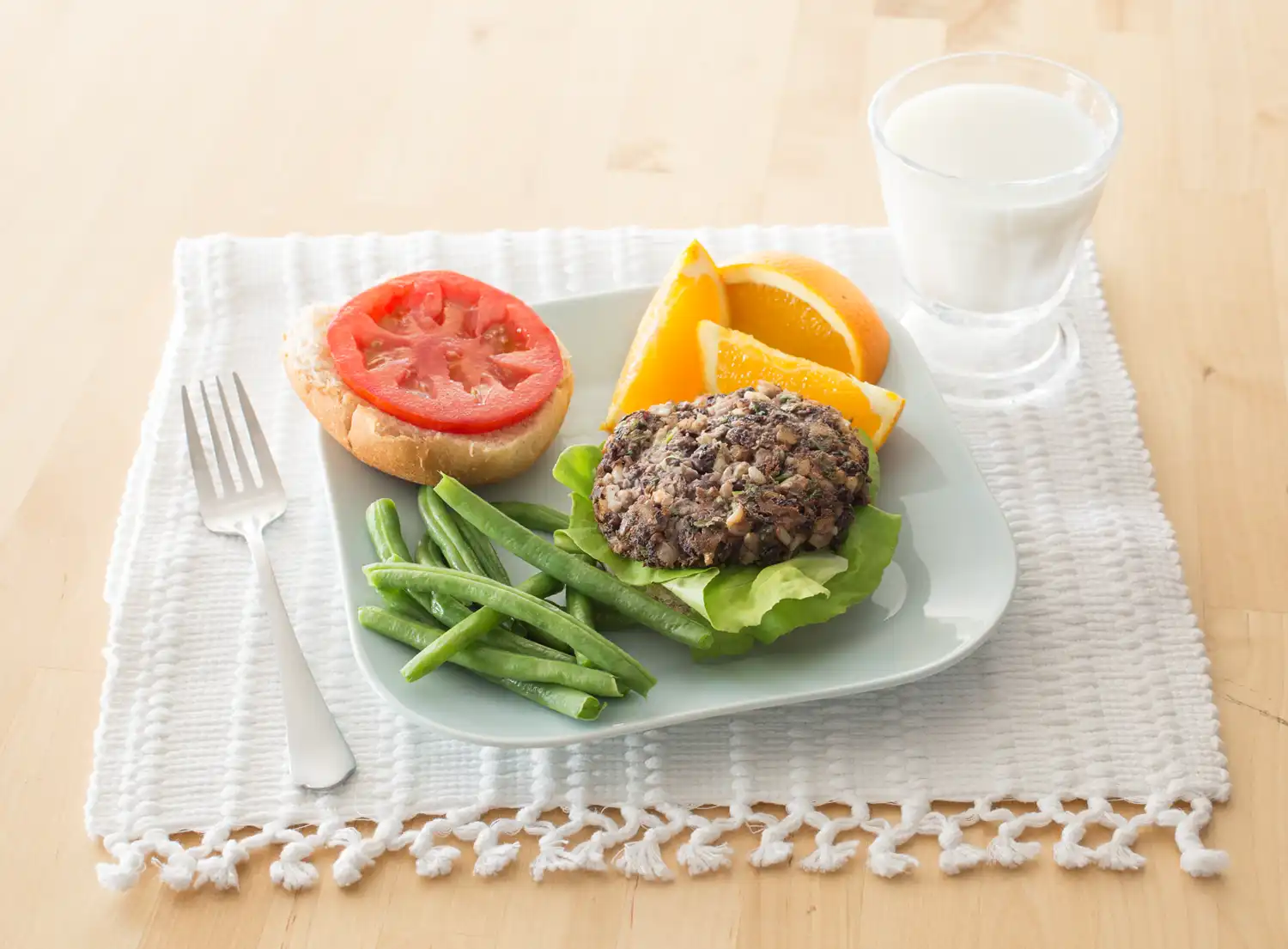 plate with black bean burger and green beans