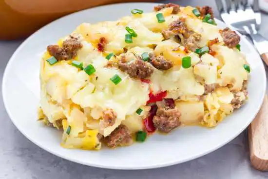 white plate with a square of egg and sausage casserole
