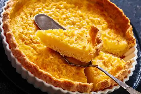 sliced chess pie with a slice on a scoop being removed