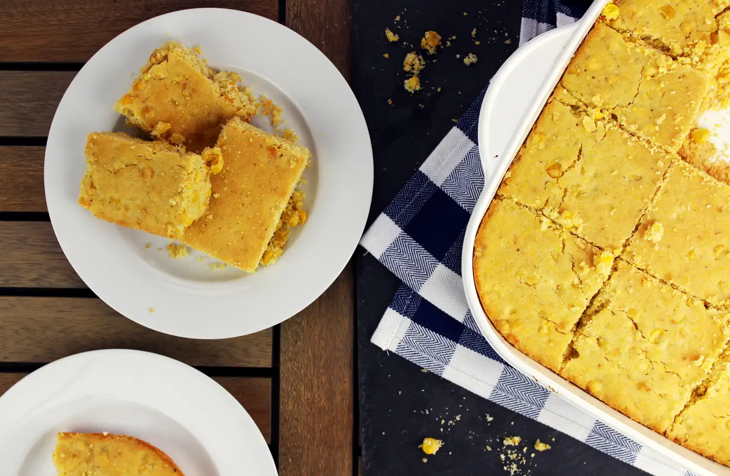 pan of cornbread with a serving on a plate next to it