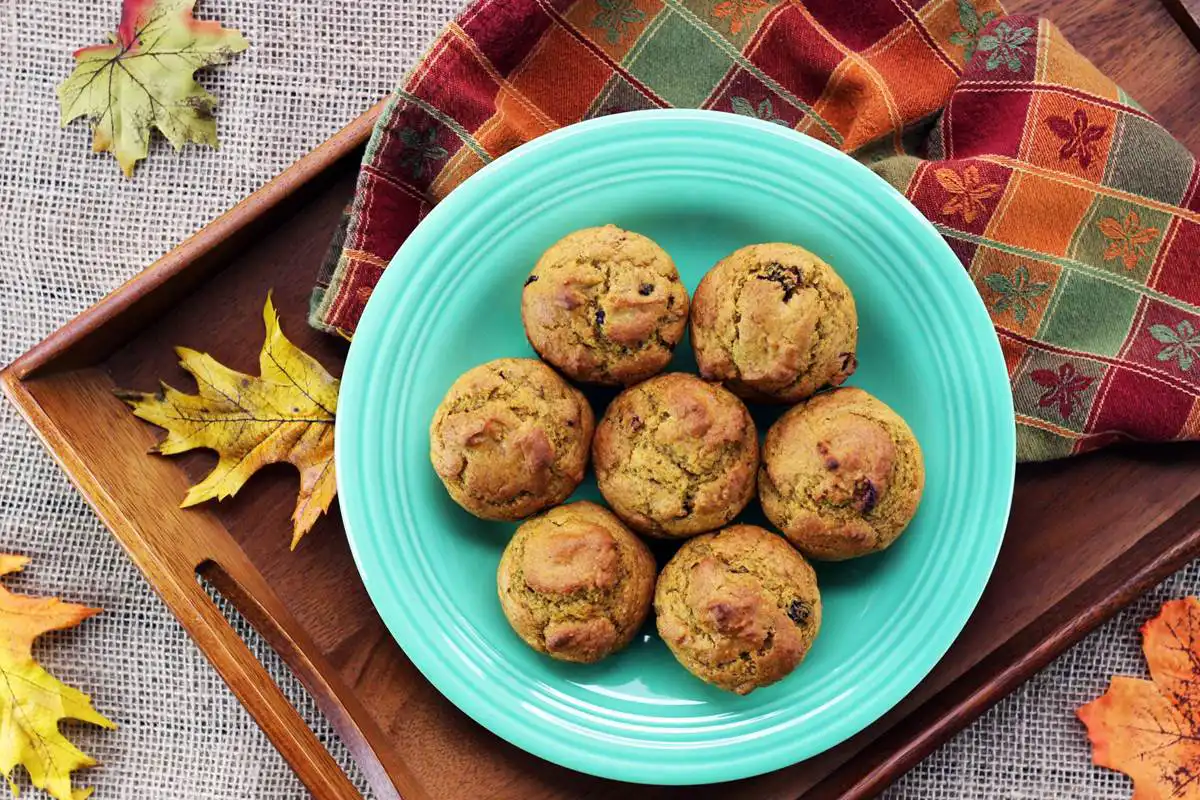 plate with cranberry pumpkin muffins
