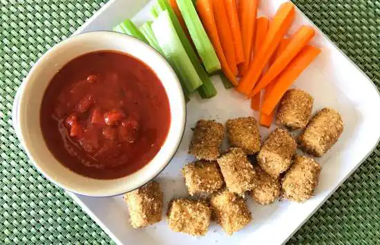 plate with a pile of tots and veggies