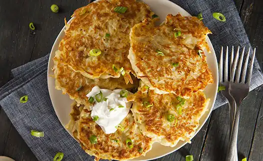 potato pancakes with spatula next to them