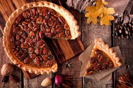 pecan pie with a slice taken out to the side