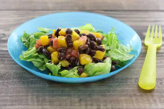 blue bowl with tropical bean salad
