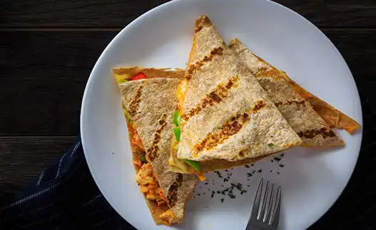 white plate with veggie quesadillas