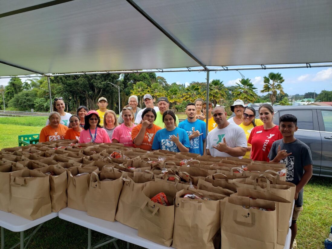 The YMCA Hilo team prepare for their weekly summer food distribution. 