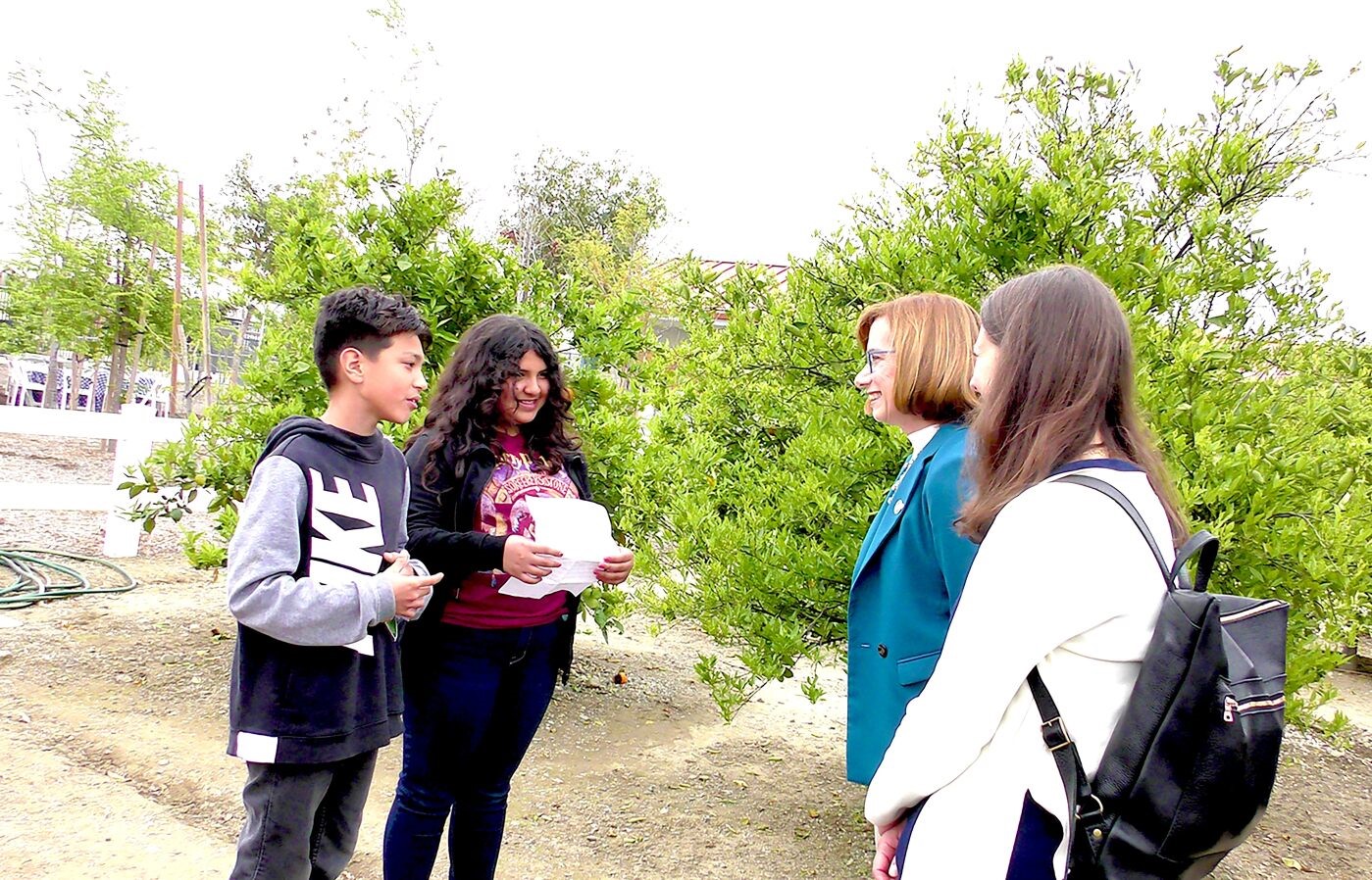 students presenting in a school garden