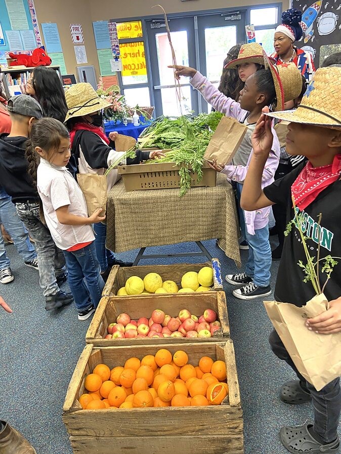 students with fruit bins