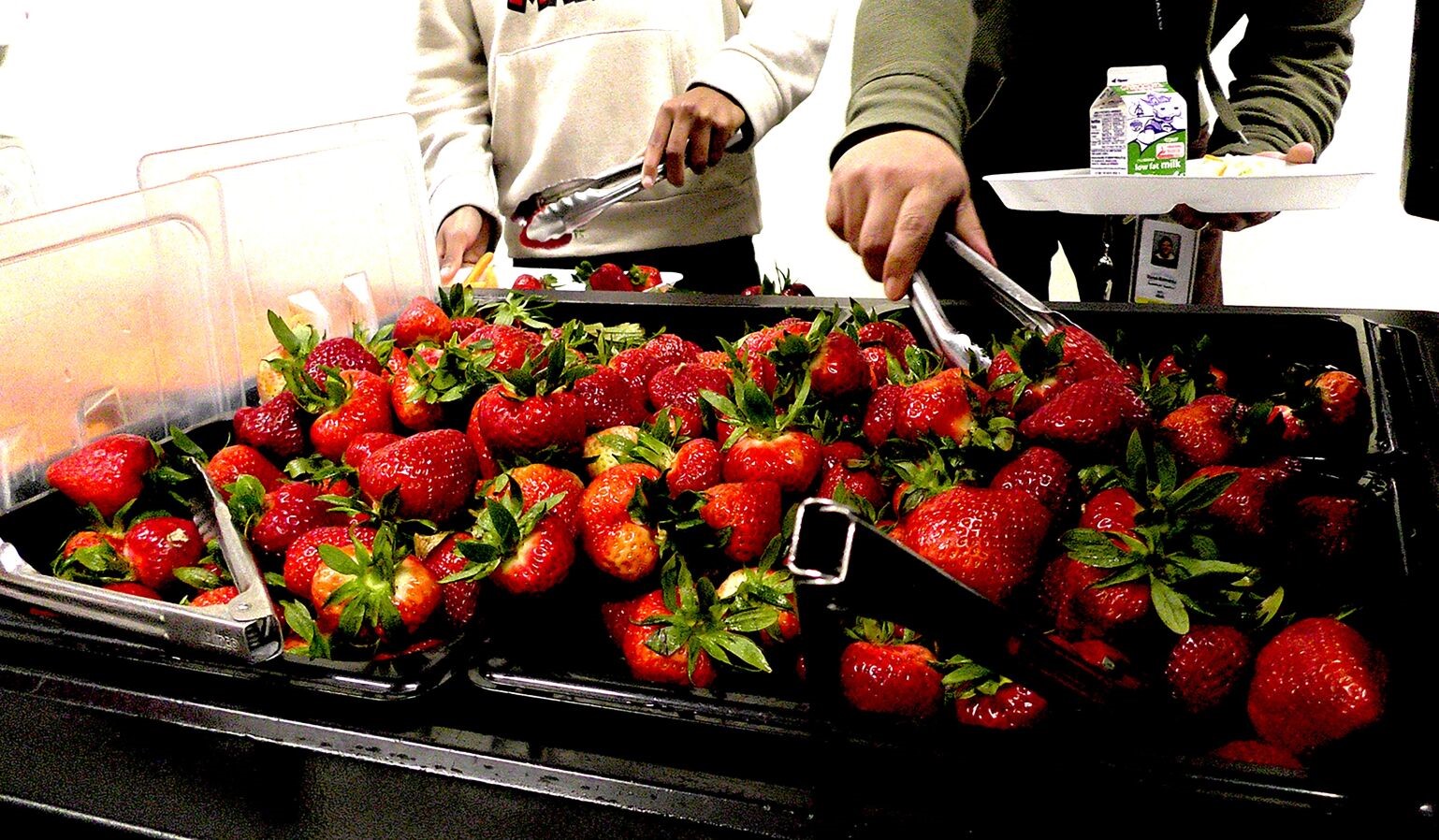 students serving themselves strawberries