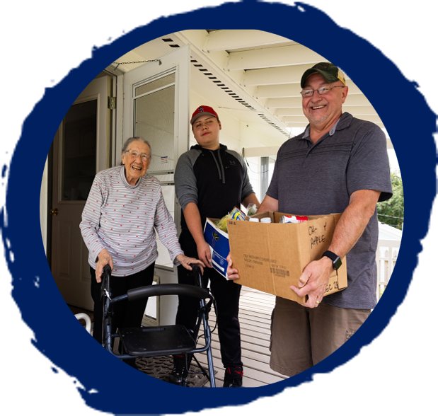 navy paintbrush circle with image of fdpir food package being delivered to a woman using a walker on her front porch