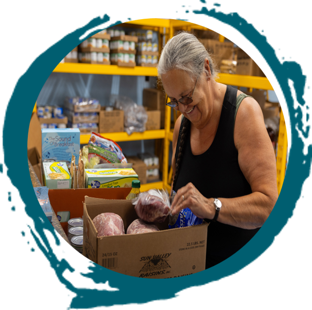 paint brush circle with image of a woman receiving a food box on top