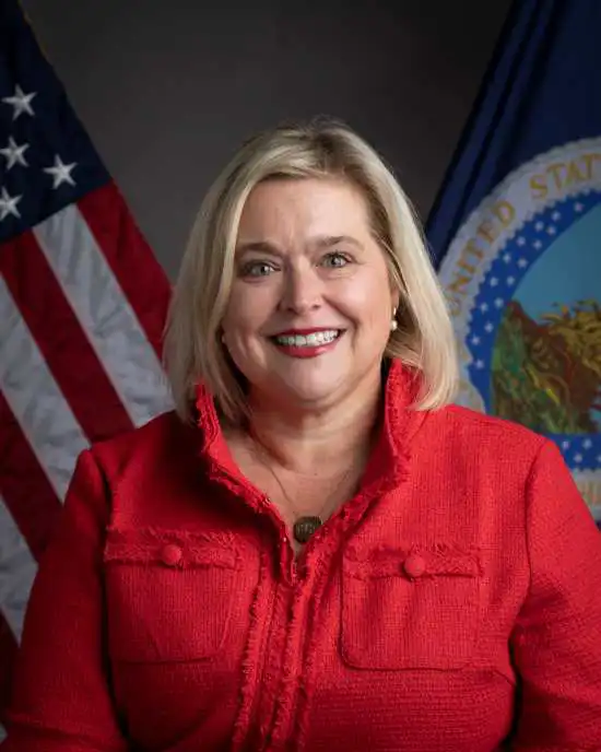 Shiela Corley in a red shirt with the U.S. and USDA flags behind her