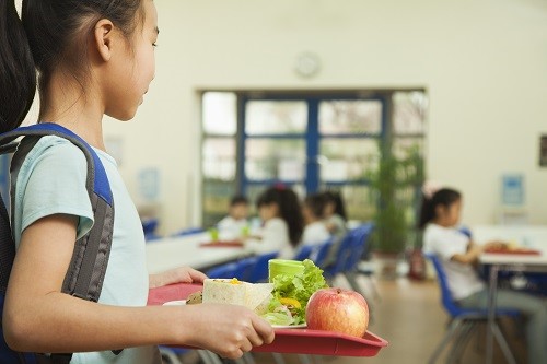 student with lunch tray