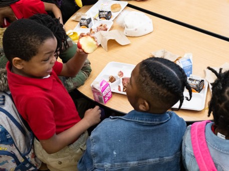 young children eating breakfast at school