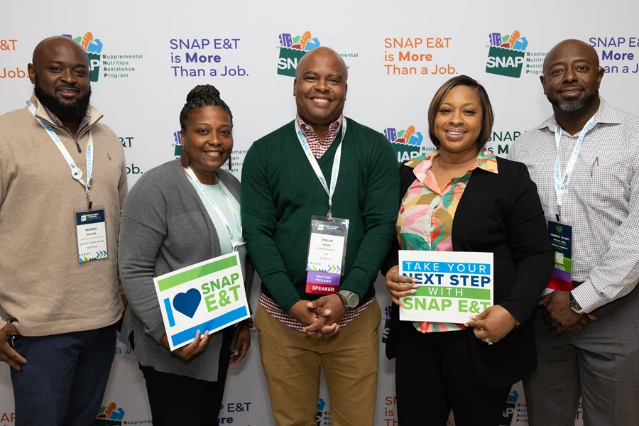 a group of people holding signs about loving SNAP E&T