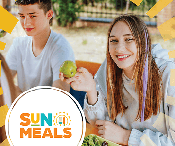 sun meals logo in bottom left corner of image of high school aged kids eating lunch outside