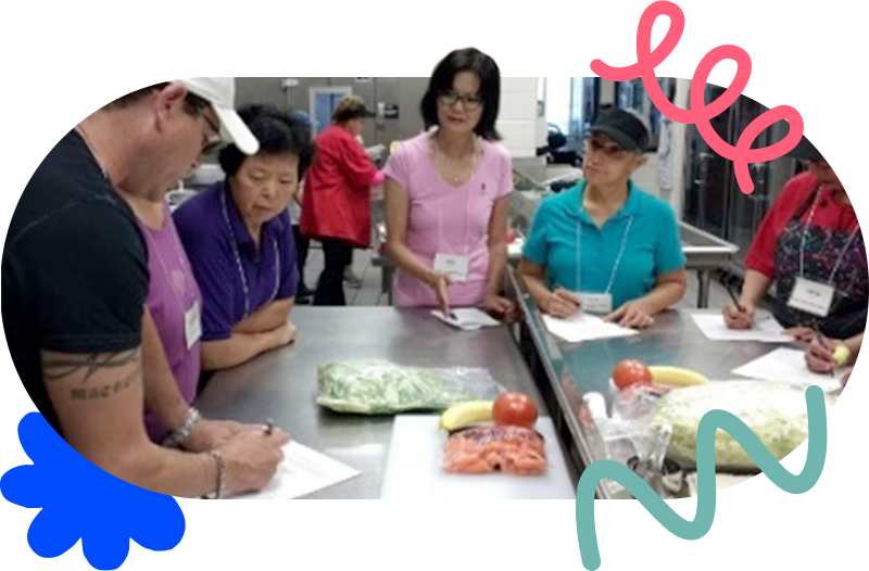 school nutrition professionals planning together in the school kitchen