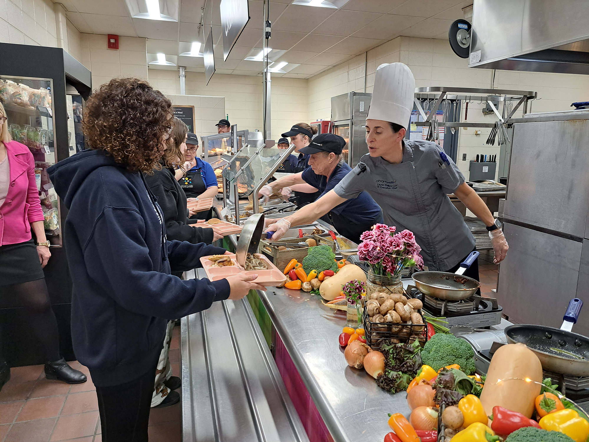 students receiving healthy meals in the cafeteria trayline
