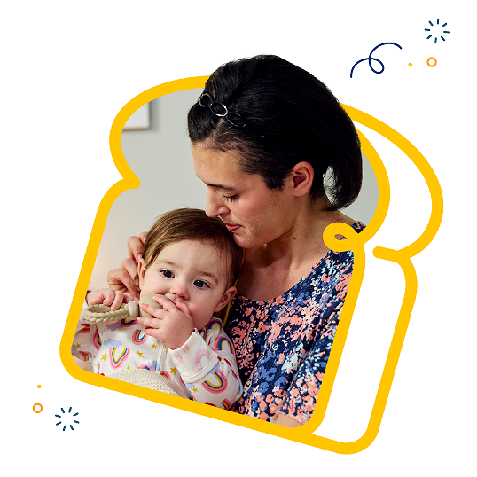 woman holding a baby embedded in a graphic of a slice of bread