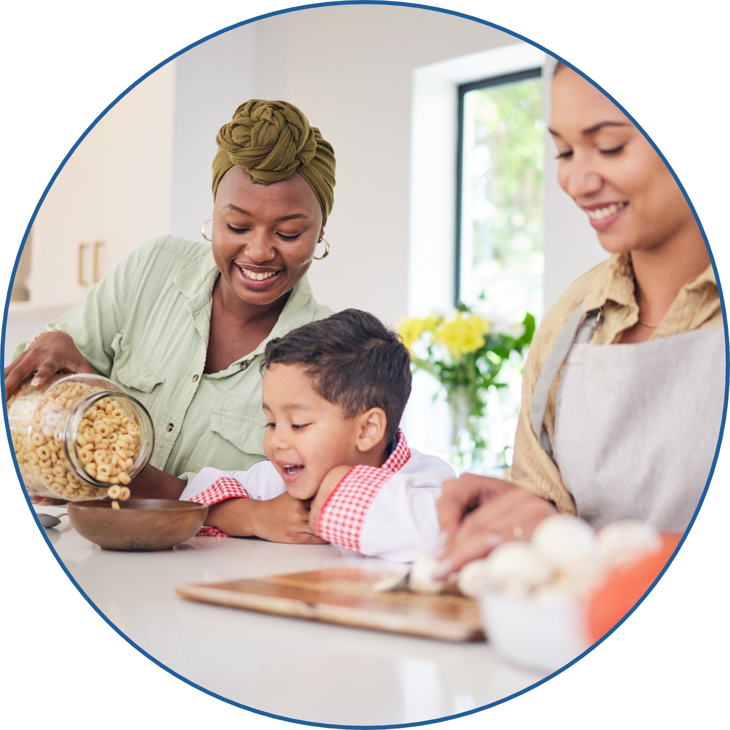 Two women feeding a small child a bowl of cereal.