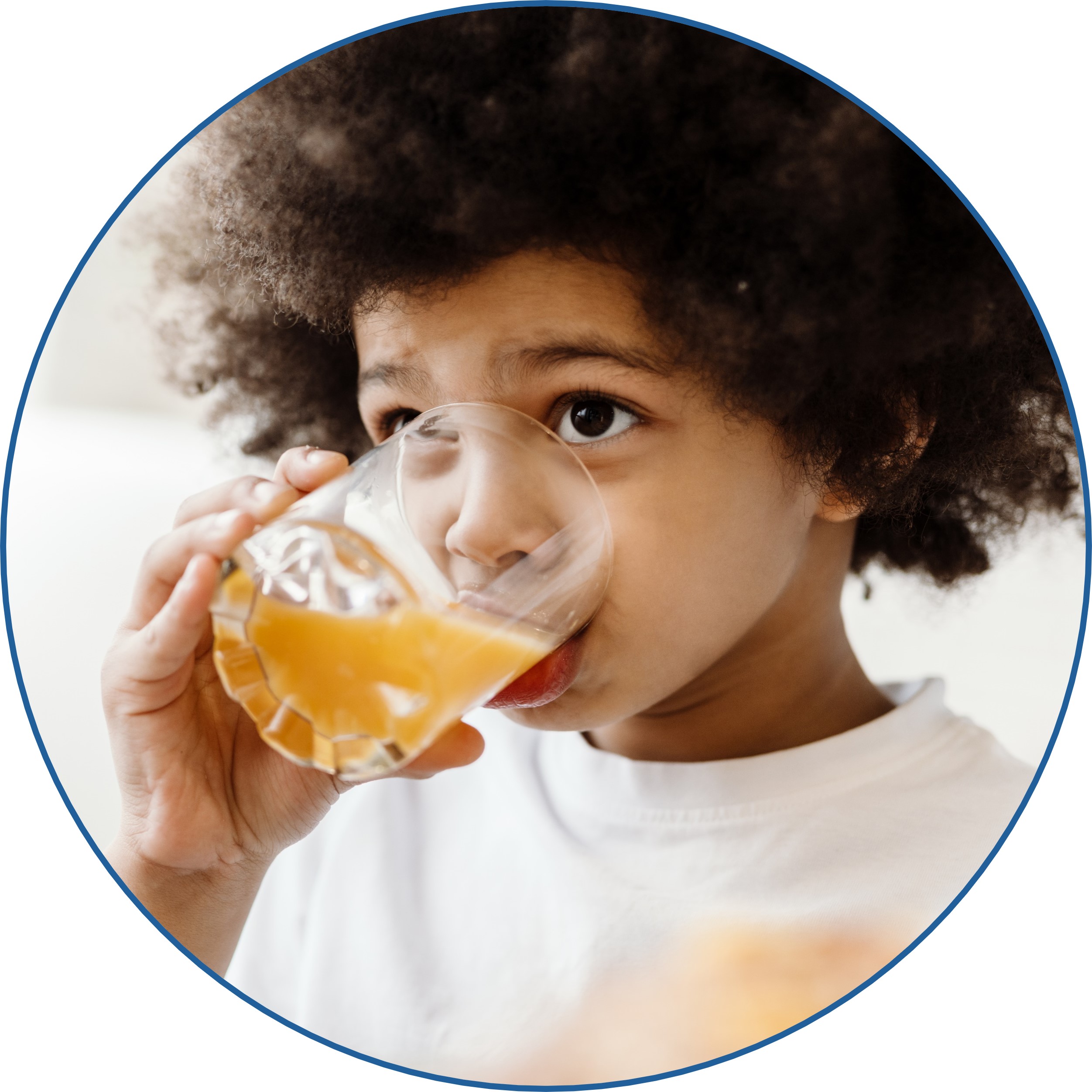 A child drinking juice out of a cup.