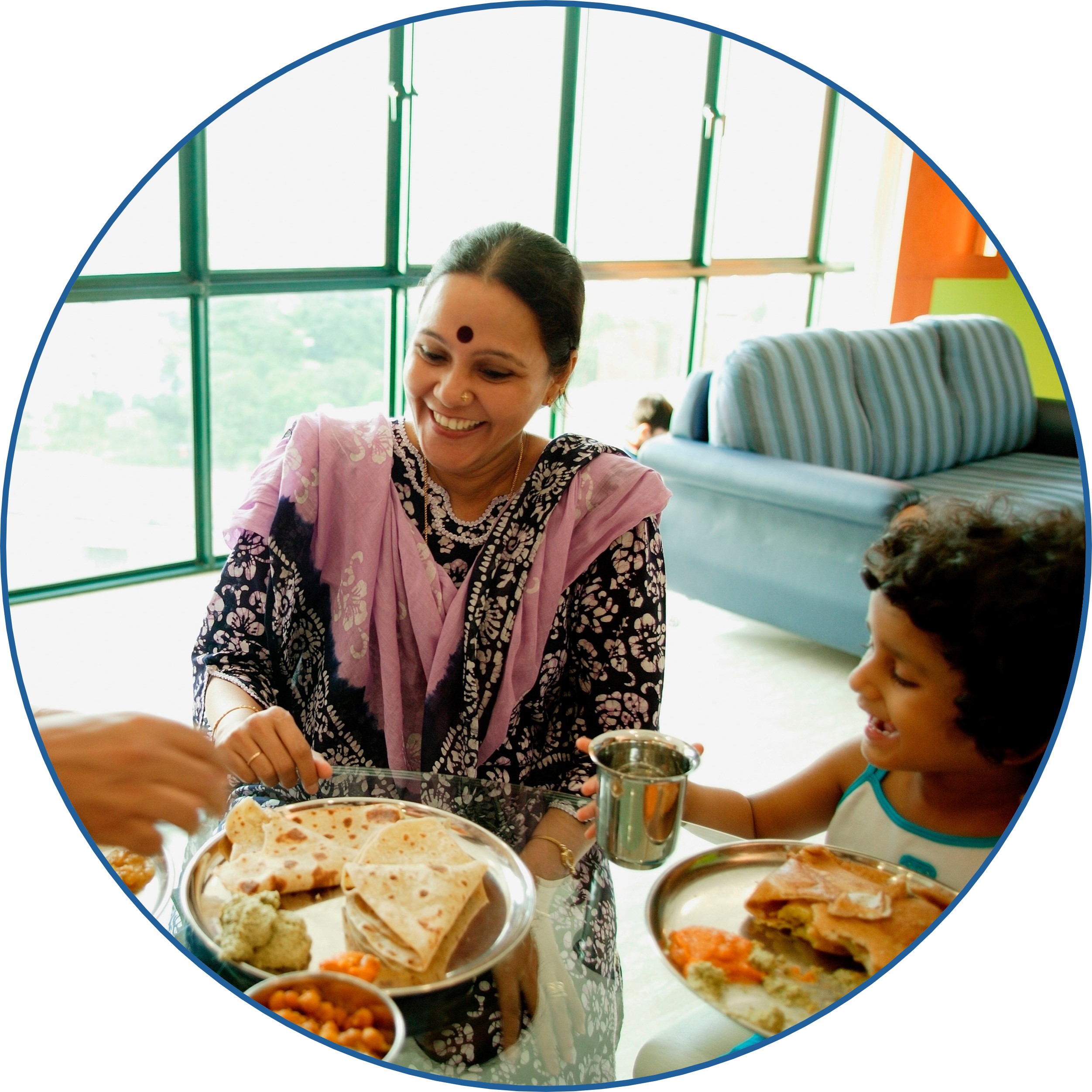 A family eating a meal at a table with whole grain naan.