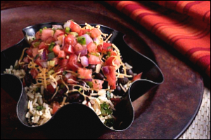 burrito bowl with diced tomato and onion topping