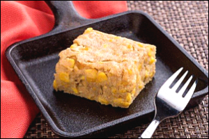 Square of corn pudding on a plate