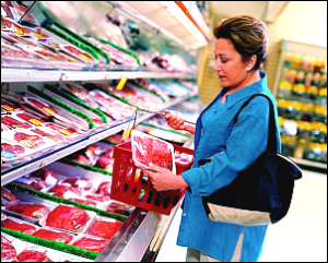 A woman shops for meat at a grocery store