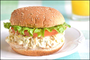 Tuna salad on a bun with lettuce and tomato