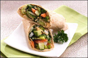 Sandwich wrap halves filled with green and orange vegetables