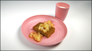 Oven Baked Pancake with Spiced Pears on a plate and a cup of milk on the side