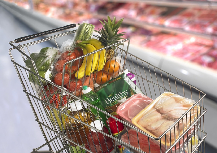 a grocery cart full of healthy food items