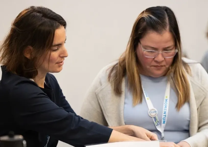 a woman providing job training to another woman