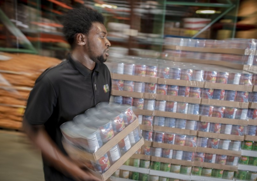 man carrying cans