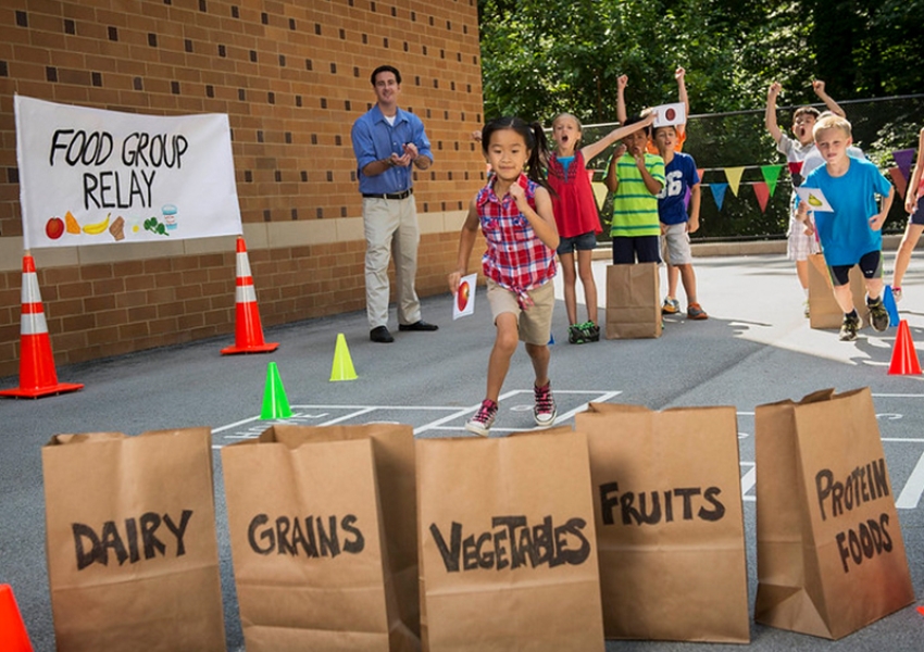 school children participating in an outdoor food group relay 