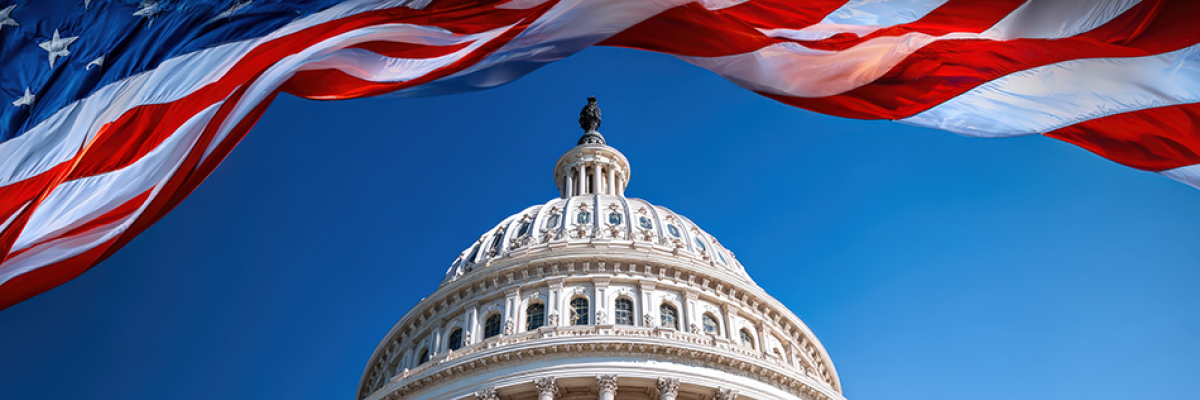 the top of the Congress building centered with a giant American flag waving above it
