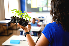 teacher holding plants