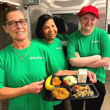 school nutrition team holding tray