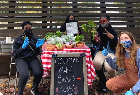 Teacher and students at their market stand