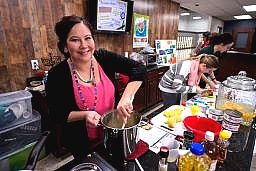 woman stirring a pot during a food demo