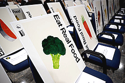 posters on chairs saying eat real food