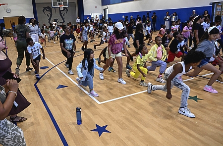 kids doing lunges in a school gym