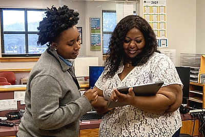 two women looking at an ipad screen in a wic clinic