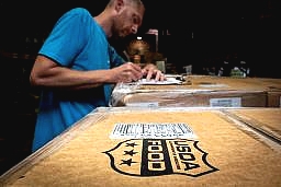 a man signing documents on a box of USDA Foods